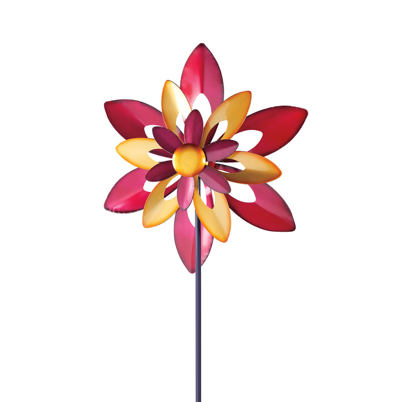 Outdoor garden wind spinner with multicolor starflower petals on a dark metal pole