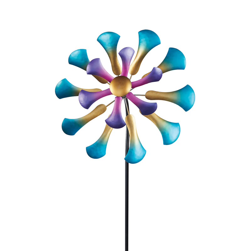Multicolored flower wind spinner with teal and purple blades on black pole, gold center