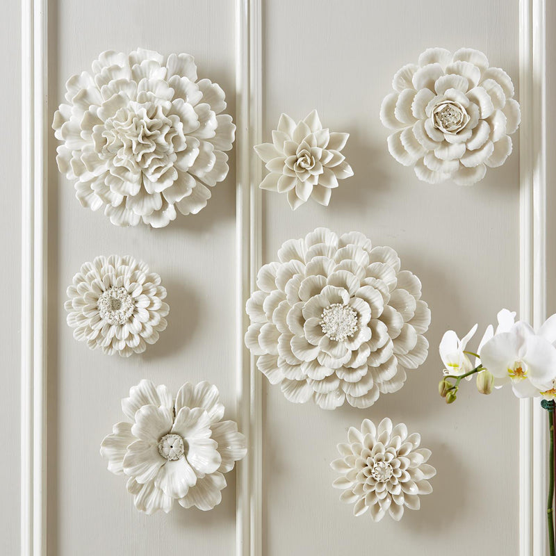 Set of seven white porcelain floral wall sculptures, textured 3D flower plaques
