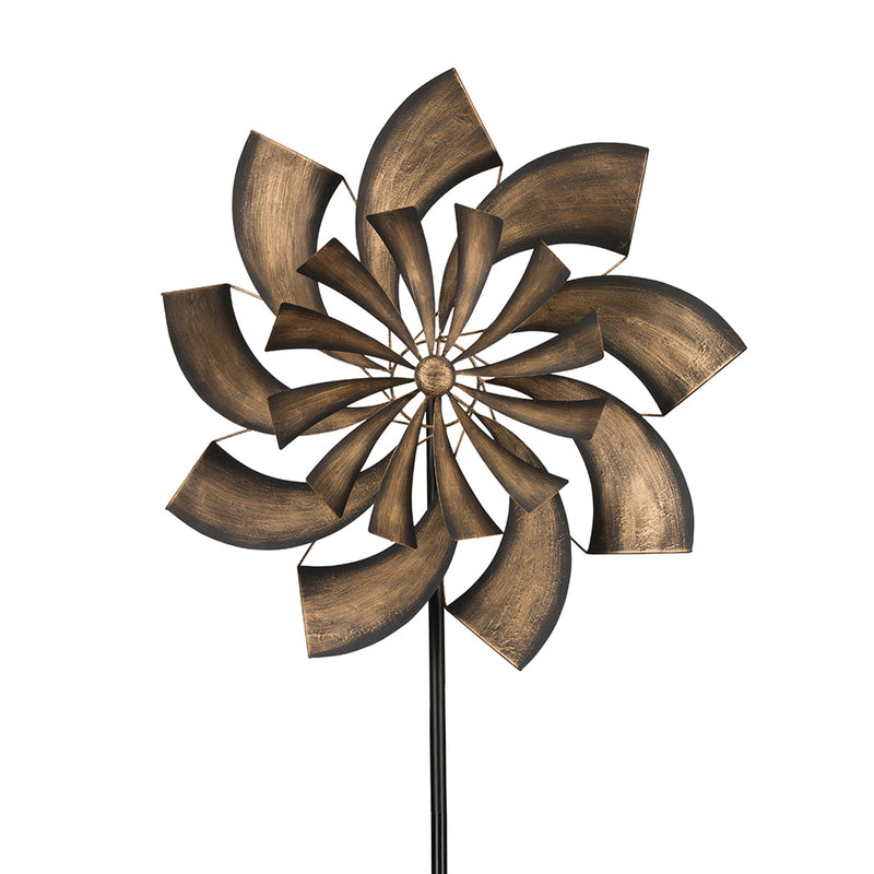 Outdoor garden wind spinner with bronze metal fan blades and central hub on a pole