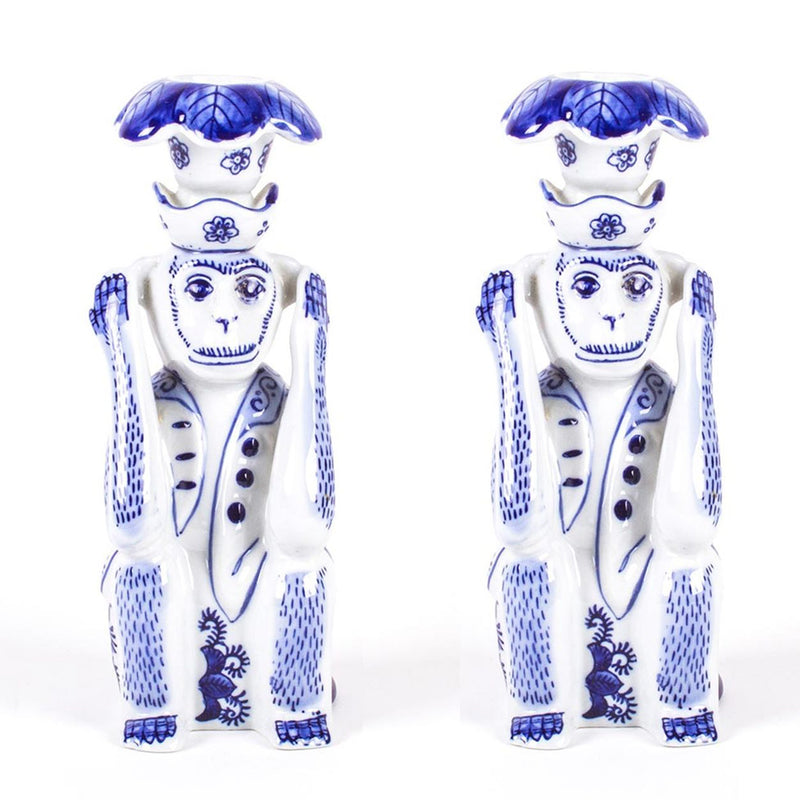 Set of 2 blue-and-white ceramic monkey candlestick holders with chinoiserie detailing.