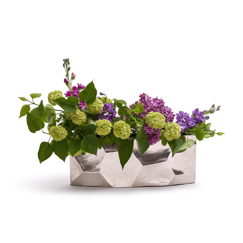 Hex-textured elongated vase in silver with geometric faceted design, holding mixed blooms