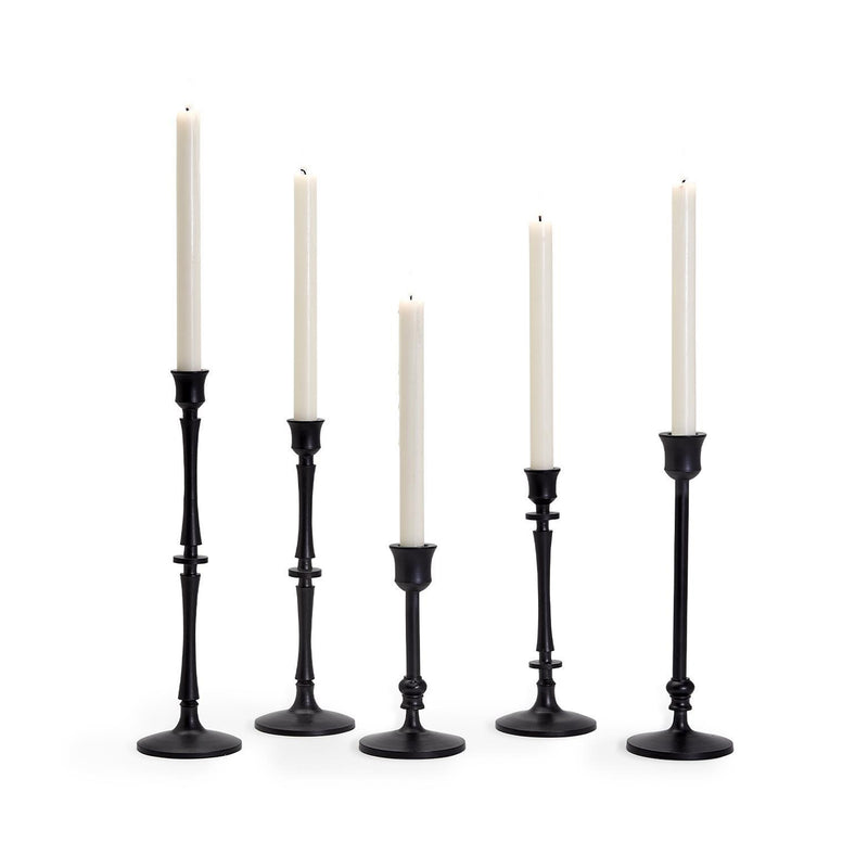 Set of 5 black metal candlesticks with five white pillar candles, varying heights