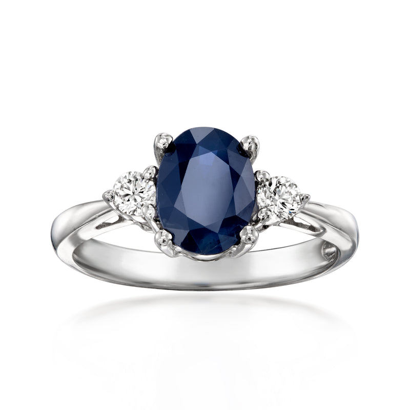 14kt white gold oval sapphire ring with dark blue center and round diamond accents
