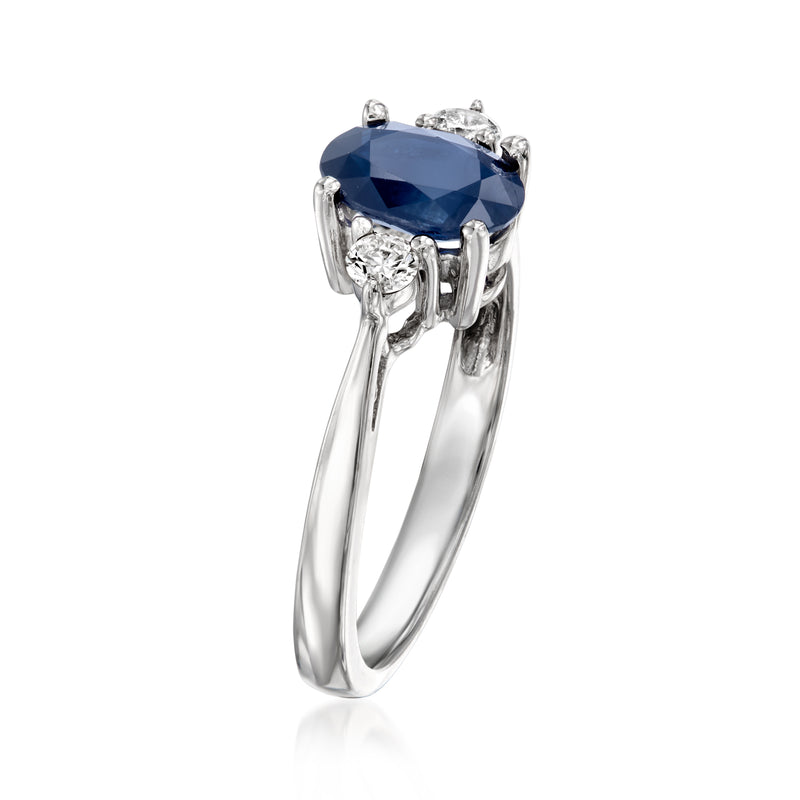 14kt white gold ring with oval dark blue sapphire, prong-set center and diamond shoulders