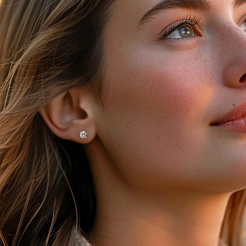 Diamond stud earrings, small round prong-set stones on ear in 14kt white gold