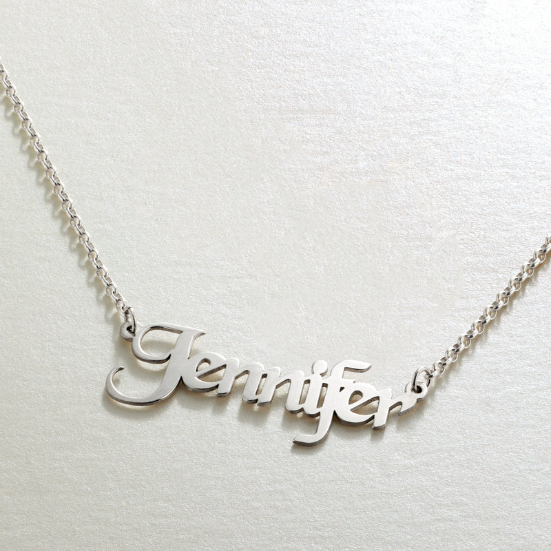 Sterling silver cursive name pendant necklace on a fine chain.