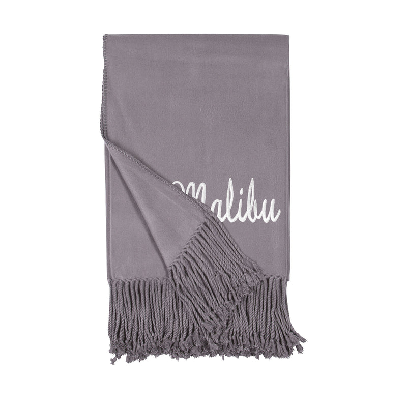 Lavender-gray throw blanket with cursive monogram and short fringe tassels