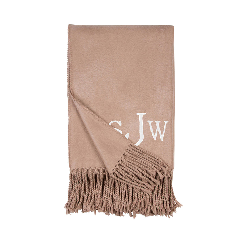 Beige sand fringe throw blanket with white JW monogram and tassel fringe