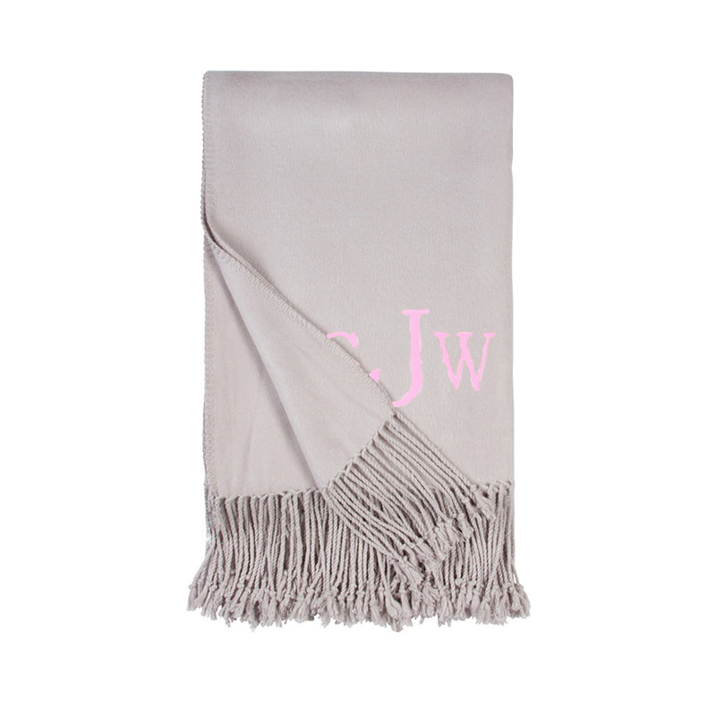 Dove grey fringe throw blanket with pink monogram J W and soft woven fabric
