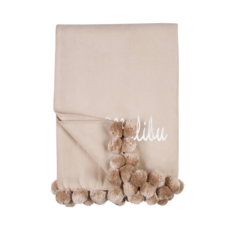 Nude pom pom throw blanket with script monogram and taupe pom fringe