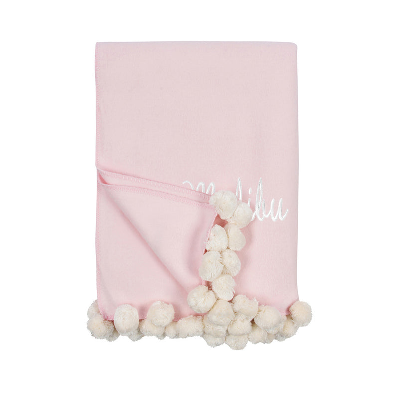 Pink and ivory pom pom throw blanket with cream pom trim and hanging accents