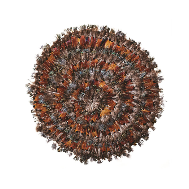Round feather placemat with orange, brown and blue peacock-style accents