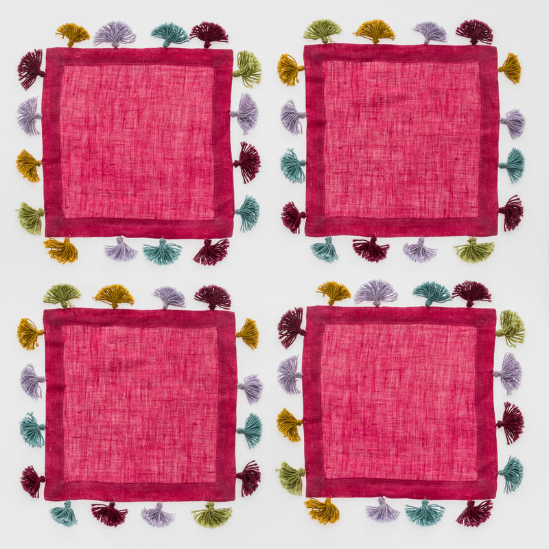 Set of four hot pink linen cocktail napkins with multicolor tassel trim