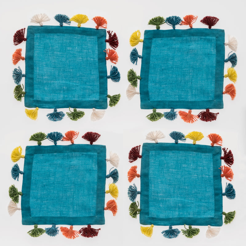 Set of 4 turquoise linen cocktail napkins with multicolor tassels around edges