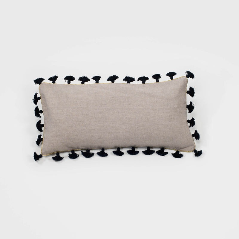 Taupe linen lumbar pillow with black tassel trim on all edges