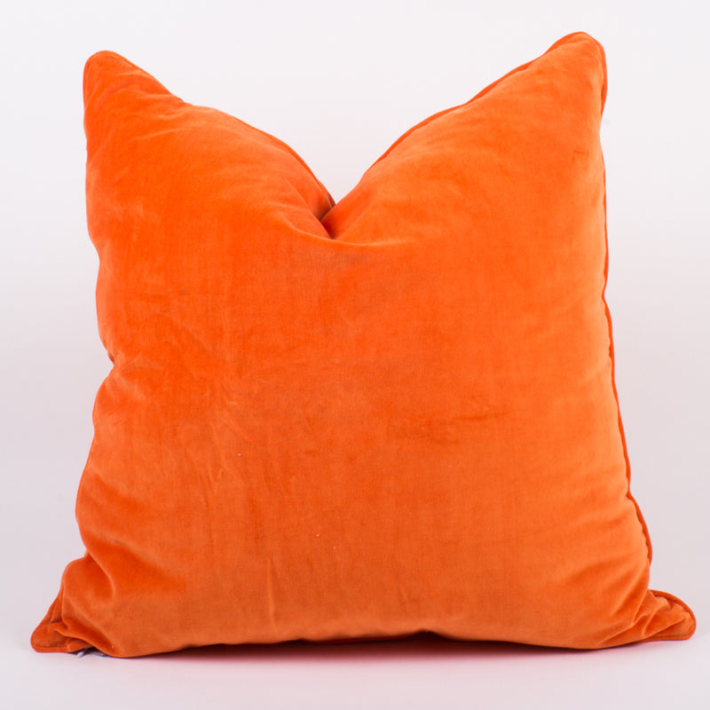 Orange velvet throw pillow with neat seam and solid textured front