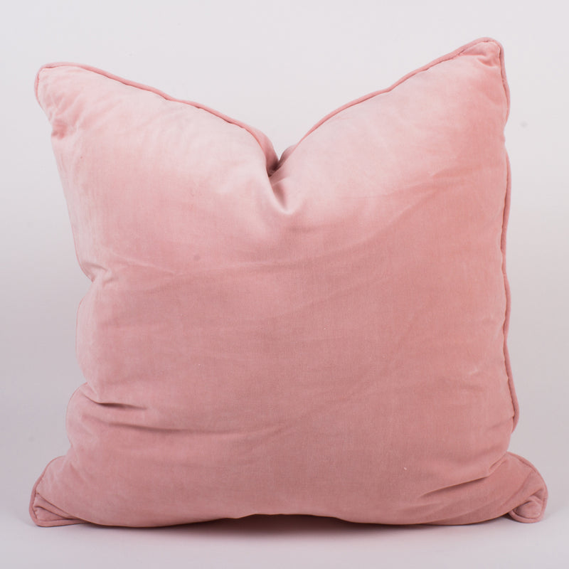 Set of 2 pale pink velvet throw pillows, square with soft rounded corners and visible seam