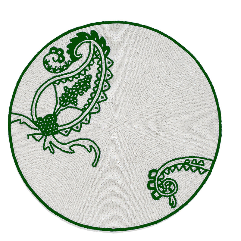 Round placemat with green paisley and floral motif on light fabric