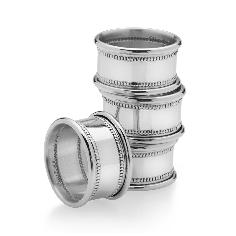 Set of 4 pewter beaded napkin rings with textured metal bands, stacked view
