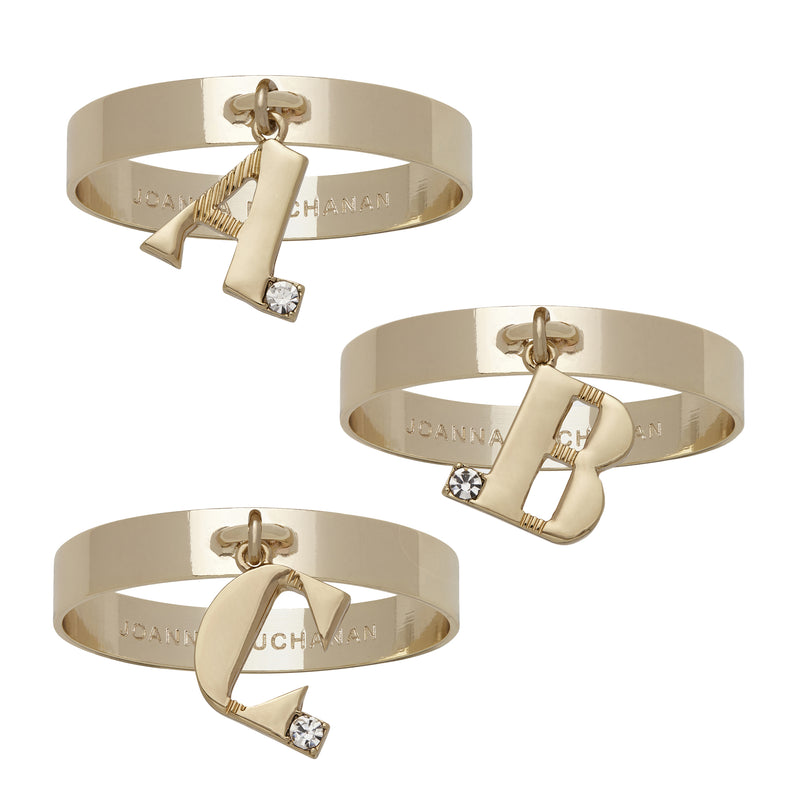 Gold-tone single initial napkin rings with cutout letter charms and crystal accents, set of 4