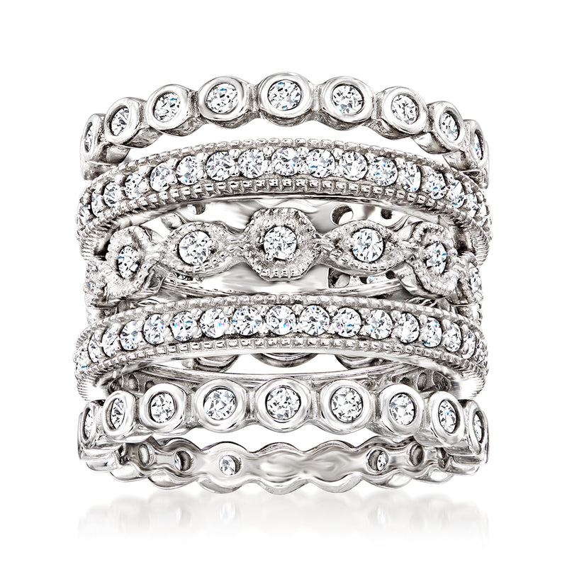 Five sterling silver CZ eternity bands stacked with round clear stones and scalloped edges