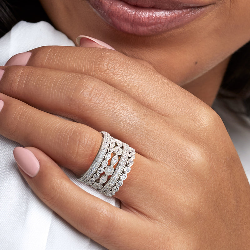 Sterling silver CZ eternity band stack on hand with slim rings and round stones