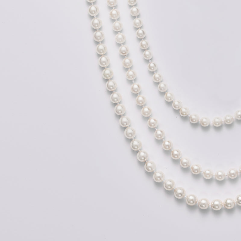 Cultured pearl necklace with two strands of round white pearls, close-up