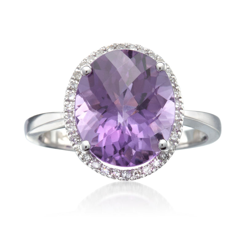 Oval amethyst center ring with diamond halo and white gold band