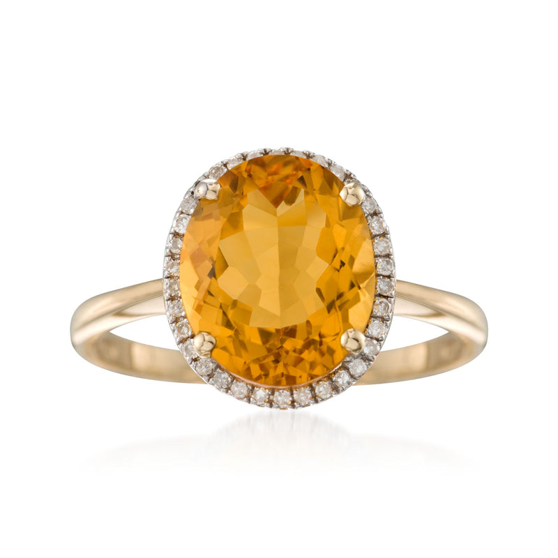 Oval citrine gemstone ring in 14kt yellow gold with diamond halo and band