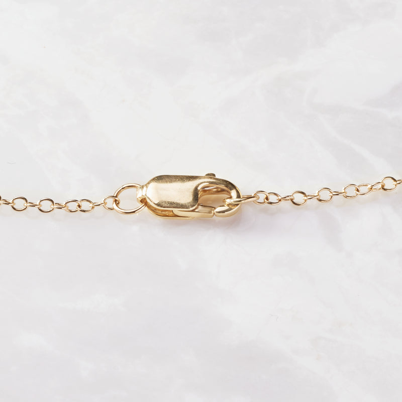 14kt yellow gold necklace clasp with linked chain and diamond station detail