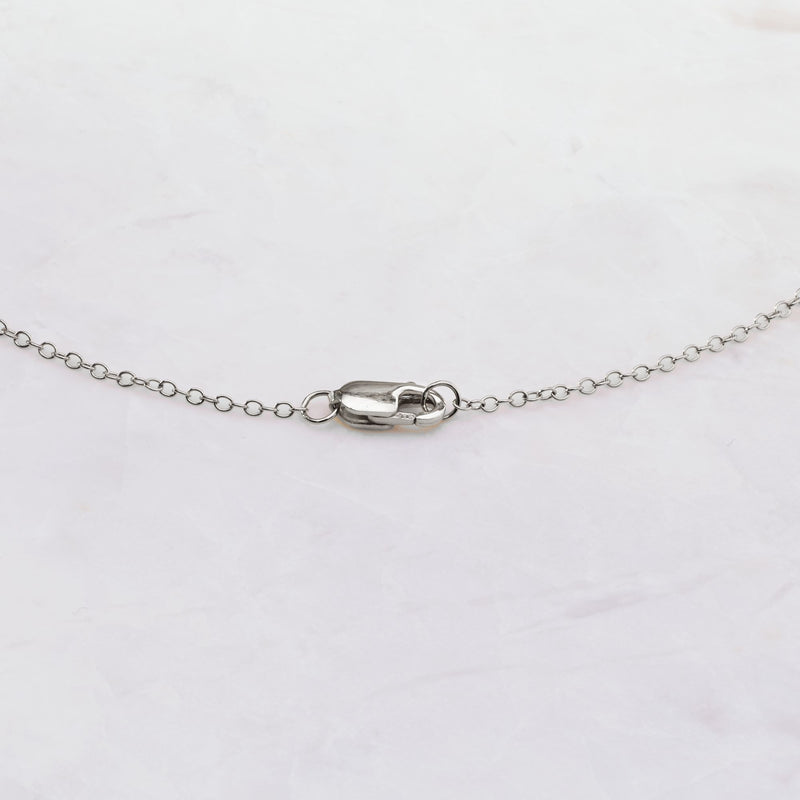 14kt white gold clasp and diamond station link on fine chain with bezel-set stones
