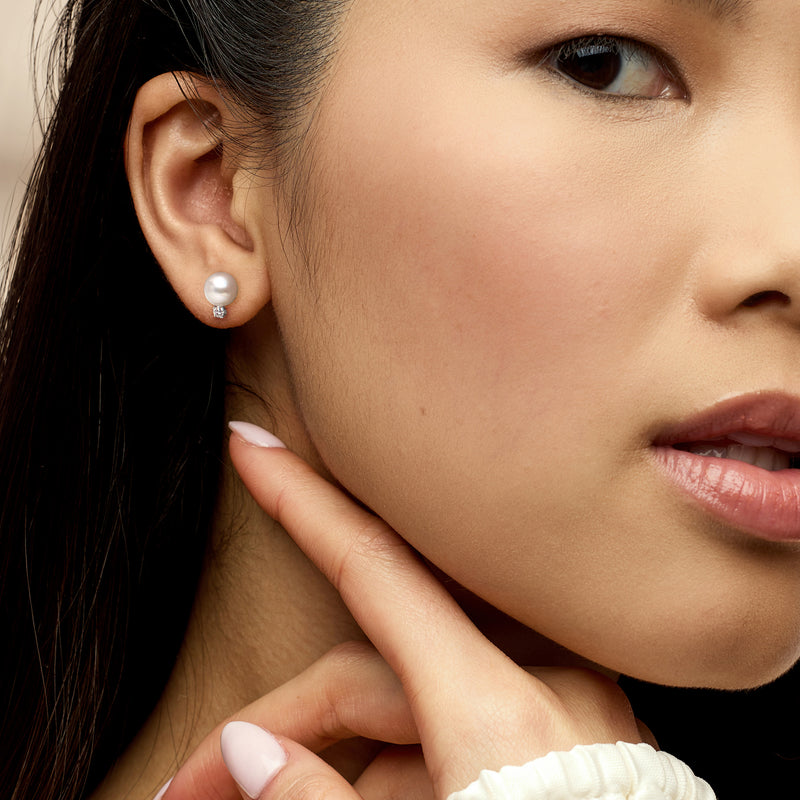 Pearl and diamond stud earring on ear, 14kt white gold
