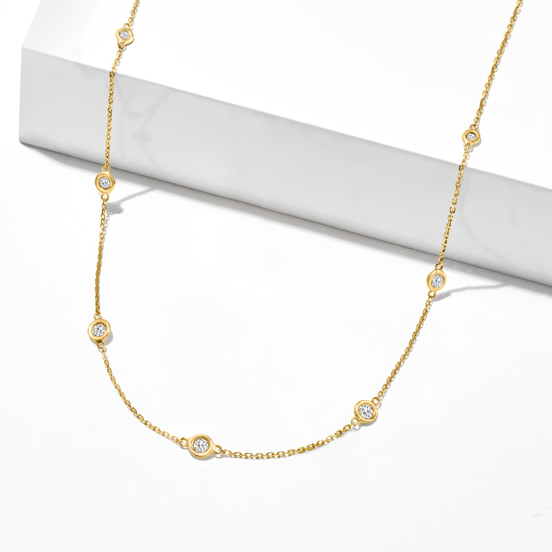 14kt yellow gold diamond station necklace, close view of linked bezel-set rounds