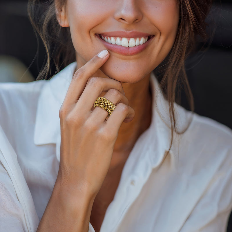 Woman's finger wearing 14kt yellow gold riso-link chain ring