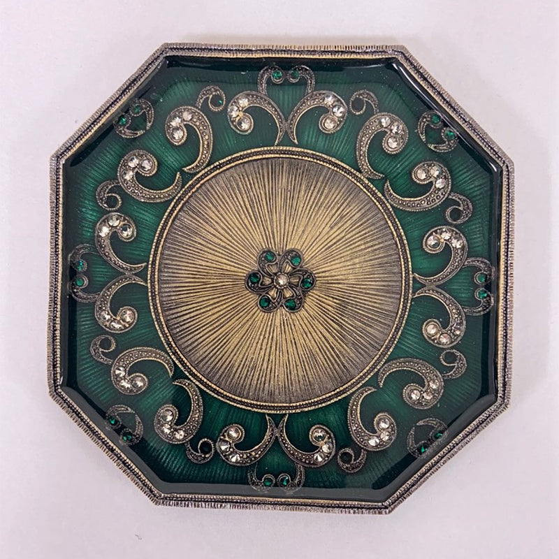 Octagonal jeweled green enamel coaster with ornate silver filigree and gold-toned center