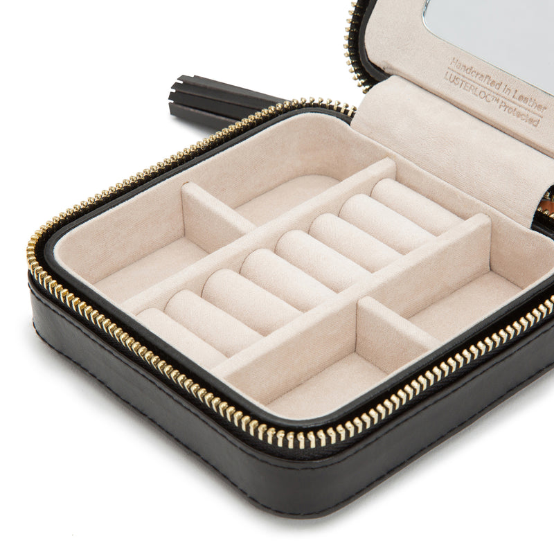 Black leather zip jewelry case interior with arranged ring and bracelet slots