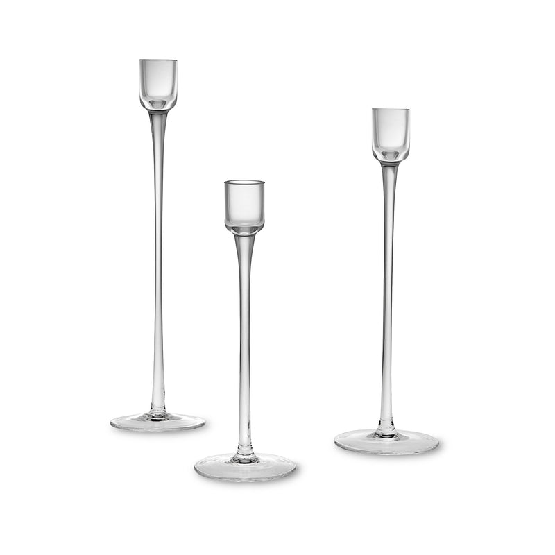 Set of three clear glass candlestick holders, three heights with flared bases