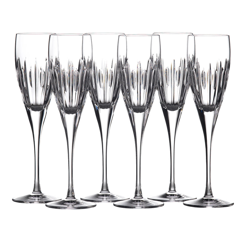 Set of six clear crystal flute glasses with ribbed, faceted bowls on stems