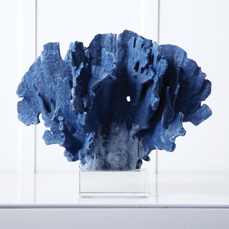 Blue coral sculpture with textured coral form on clear glass base