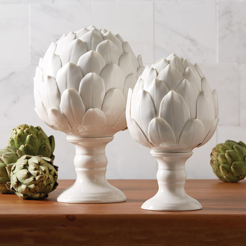 Set of two white porcelain artichoke sculptures with tiered leaf petals on pedestal bases