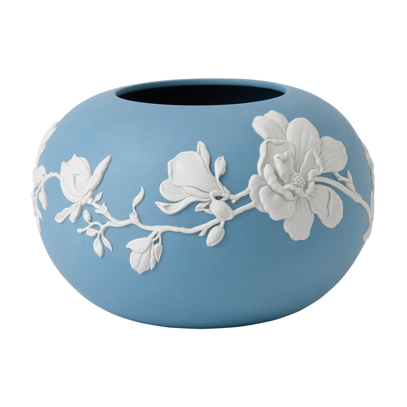 Blue ceramic rose bowl with white raised magnolia blossom relief design