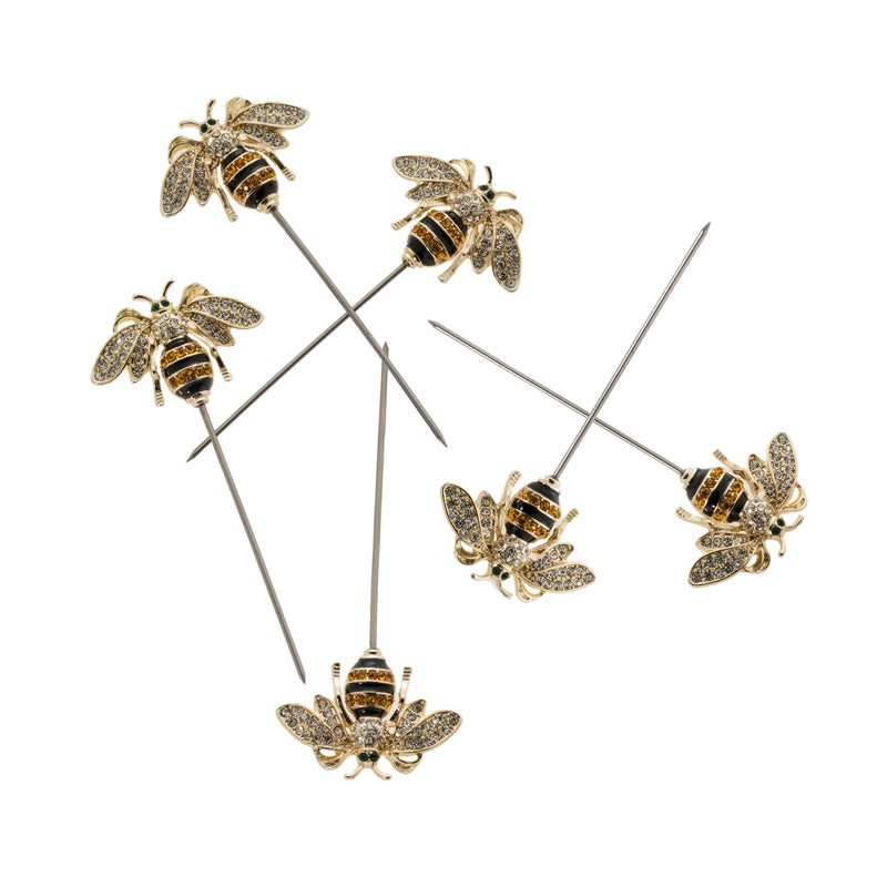 Set of 6 bee cocktail picks with gold-and-black enamel toppers on thin skewers