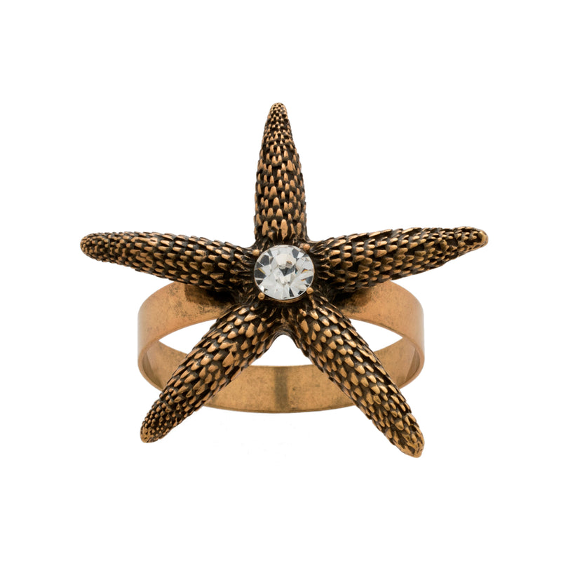 Gold-tone starfish napkin ring with textured starfish and clear round crystal centerpiece