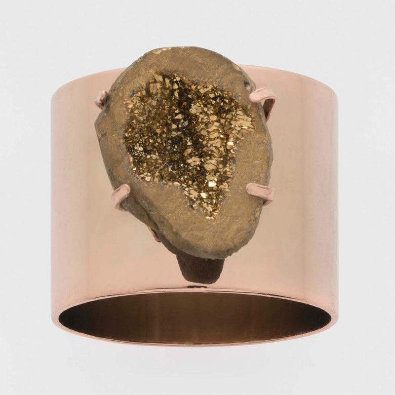 Rose-gold druzy napkin ring, oval stone with pronged setting on a dark band