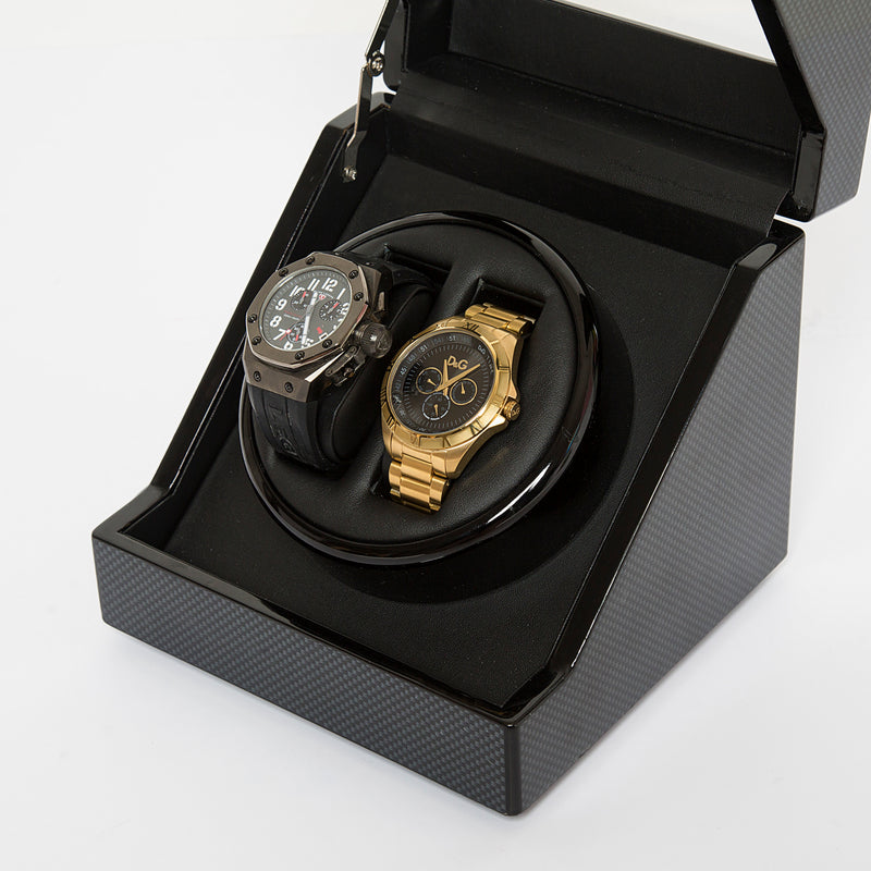 Carbon fiber watch winder open with two watches in black cushioned coils