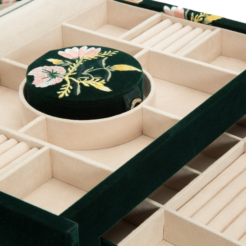 Jewelry box interior with beige dividers and round velvet compartment, floral base