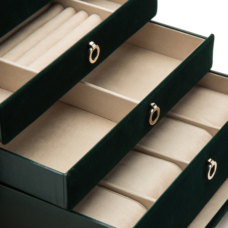 Open jewelry box with beige insert trays and three dark-green drawer fronts
