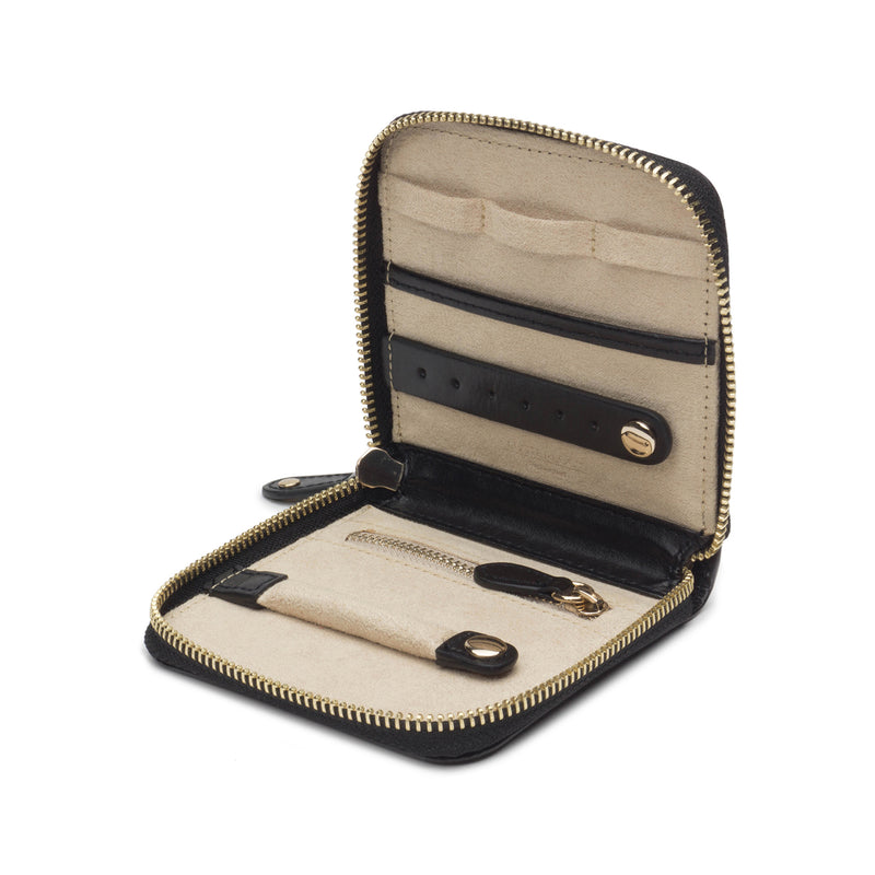 Black leather travel case with open compartments, zipper, and gold-tone hardware
