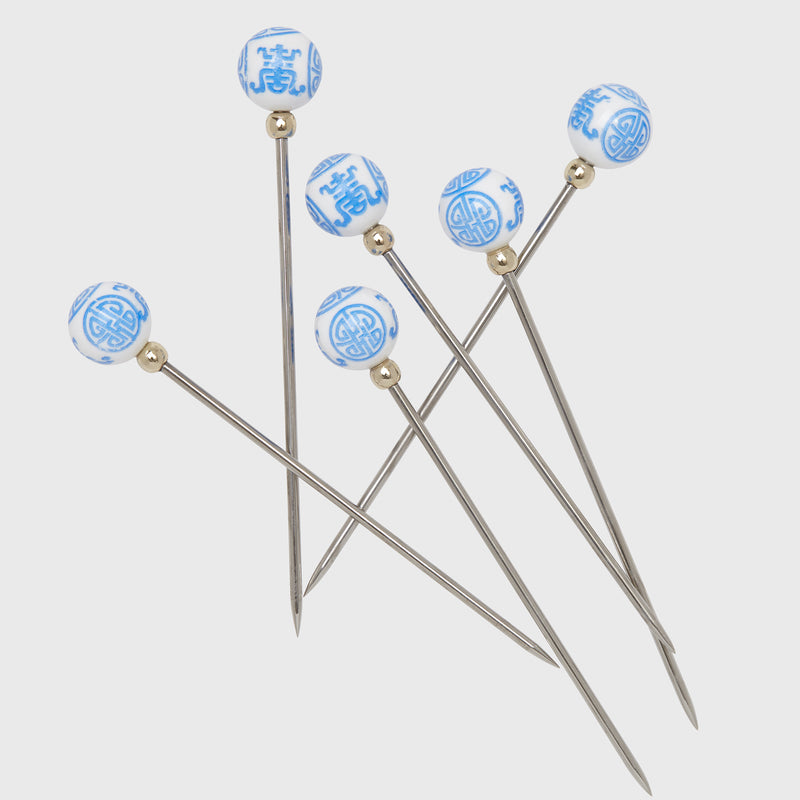 Set of 6 cocktail picks with blue-and-white round finials and slender metal stems
